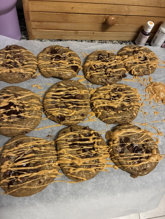Tray of chocolate chip cookies drizzled with peanut butter