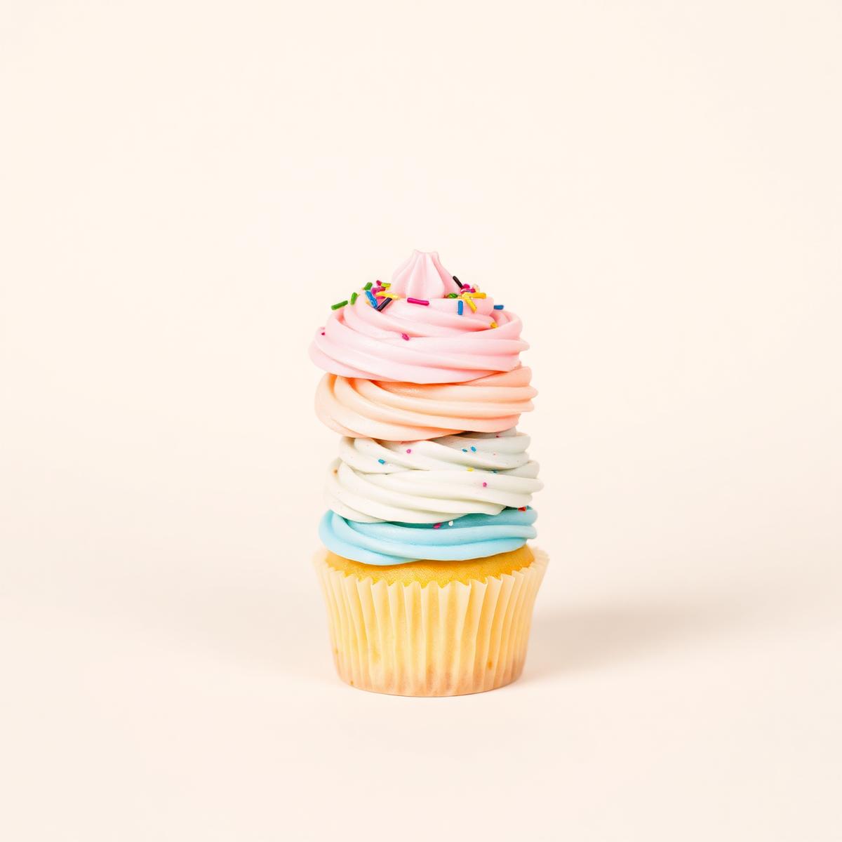 Stack of pastel-frosted cupcakes